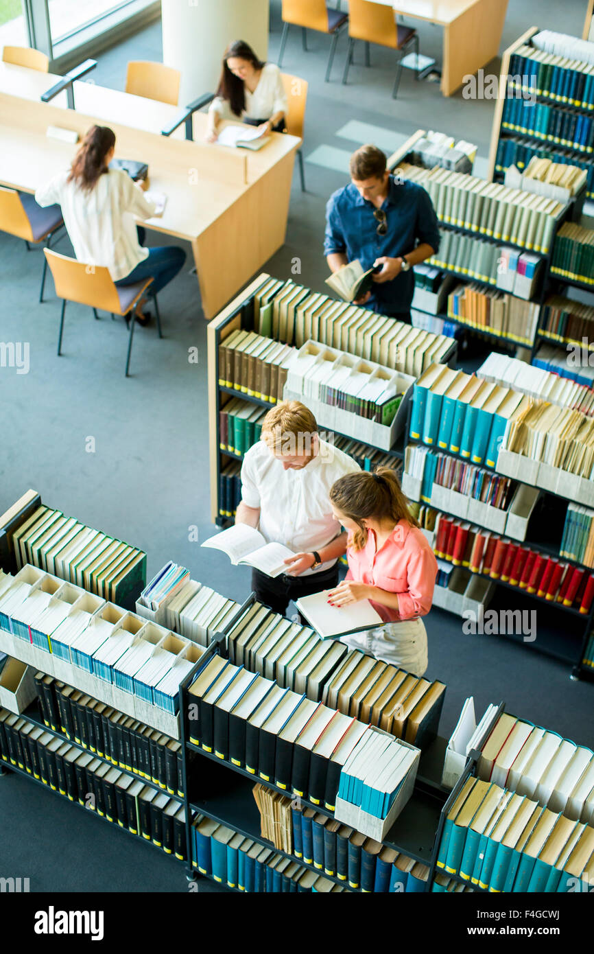 Young people in the library Stock Photo - Alamy