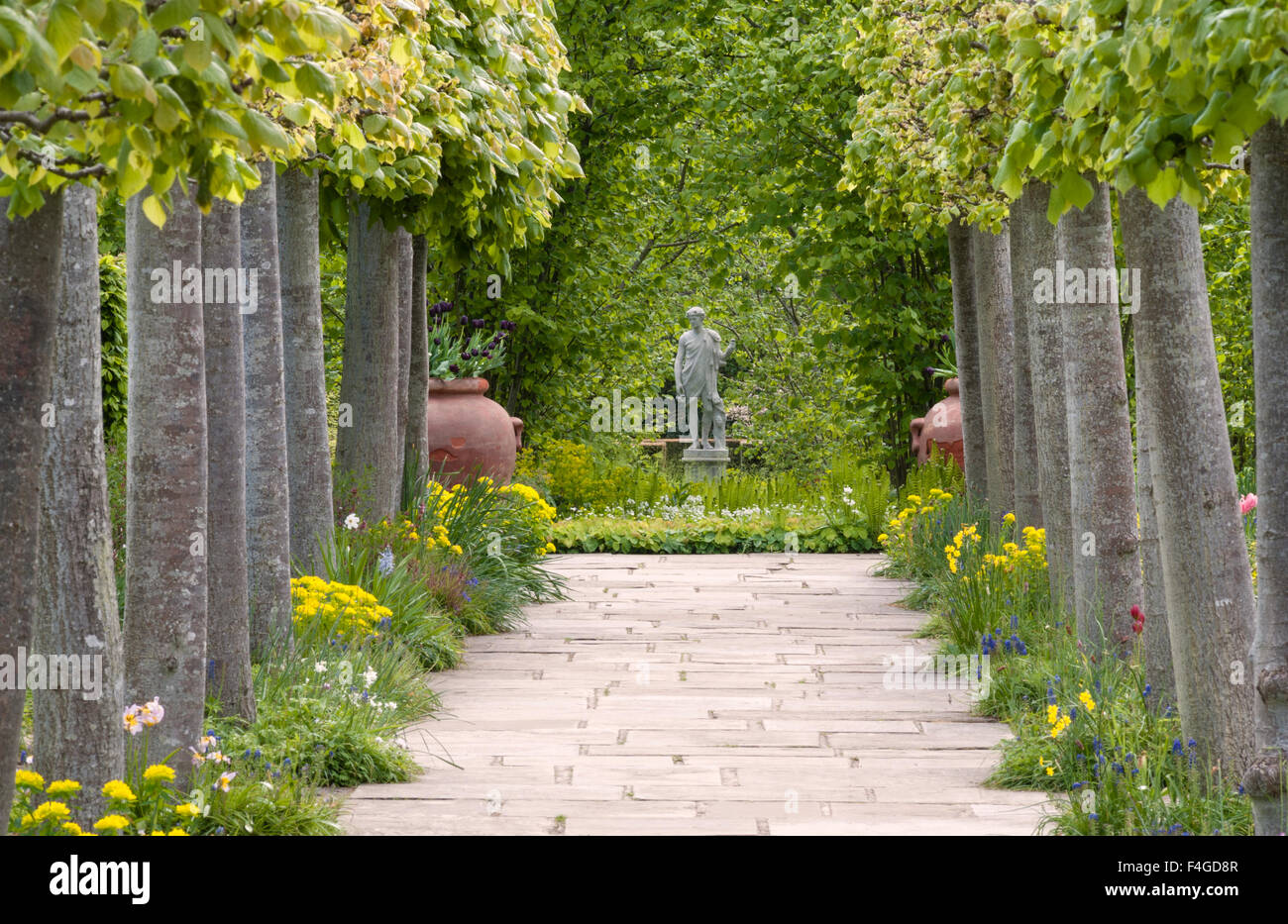 Sissinghurst Castle, Kent, UK, the famous garden made by Vita Sackville-West. The Lime Walk, towards the Nuttery, in May Stock Photo