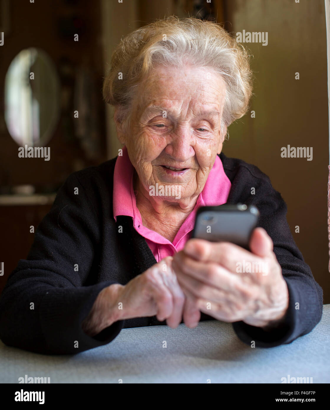 Elderly woman typing on the smartphone. Grandma. Stock Photo