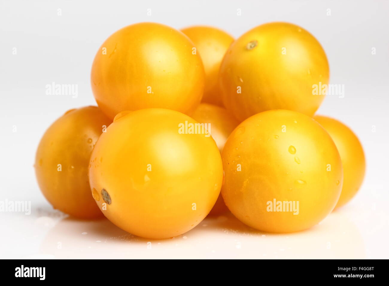 Yellow currant tomatoes isolated on a white background. Macro. Stock Photo