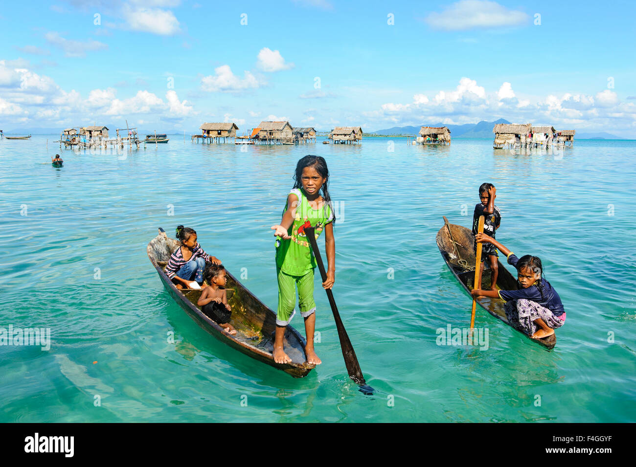 Unidentified Borneo Sea Gypsy kids on a canoes in Bodgaya Mabul Maiga ...