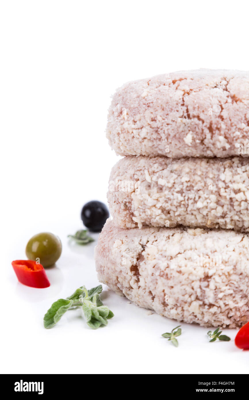 three raw cutlet with breading from on side on white background Stock Photo