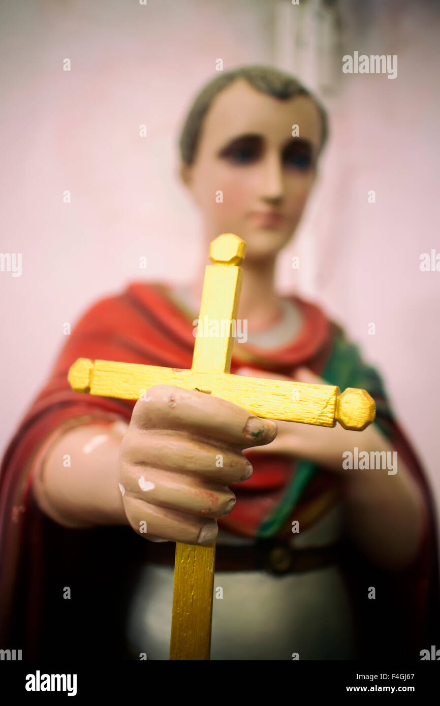 Religious Statue Holding Gold Cross on a Church alter in Rio de Janeiro, Brazil Stock Photo