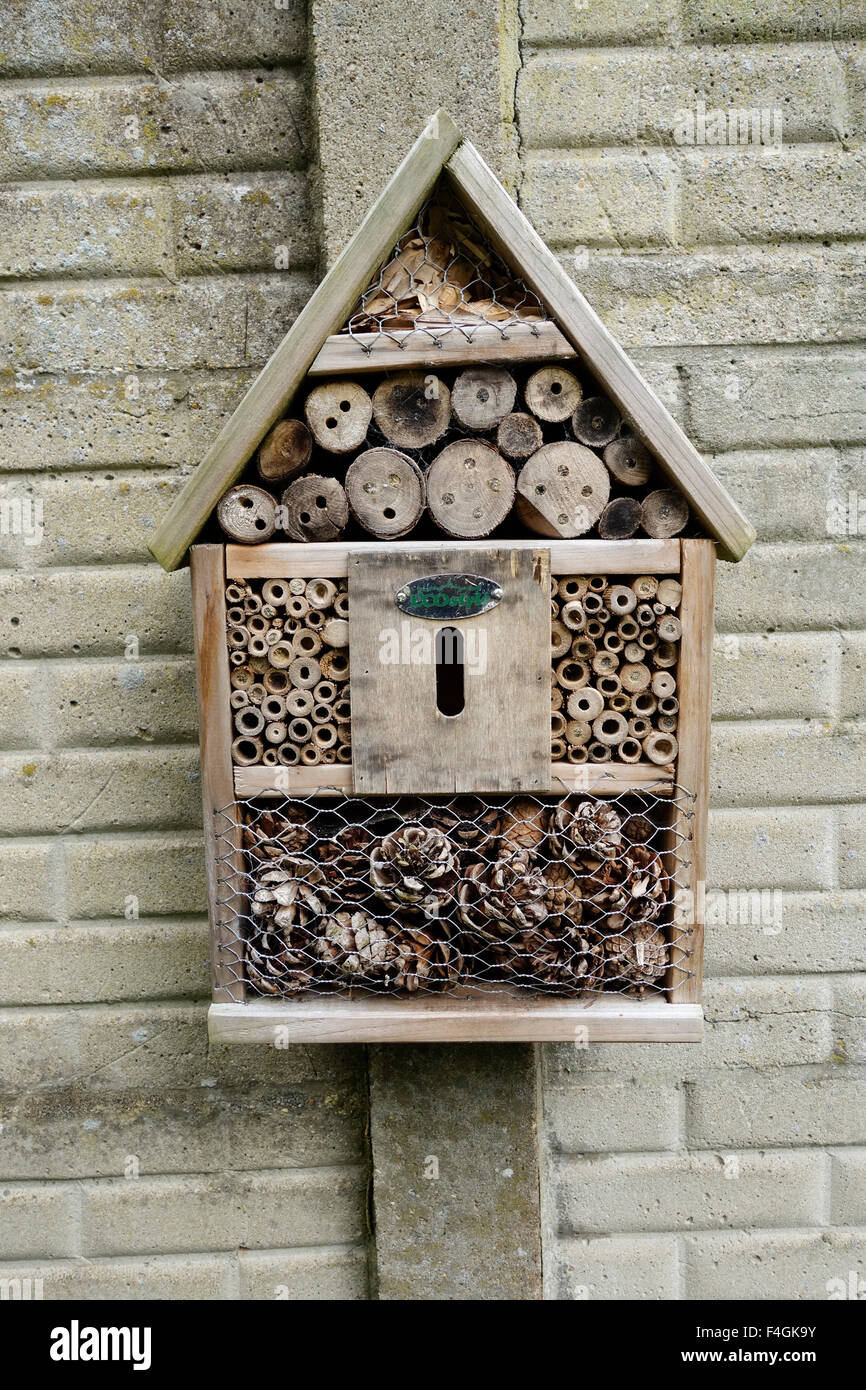 Insect house, artificial habitat to attract insects in garden. Stock Photo