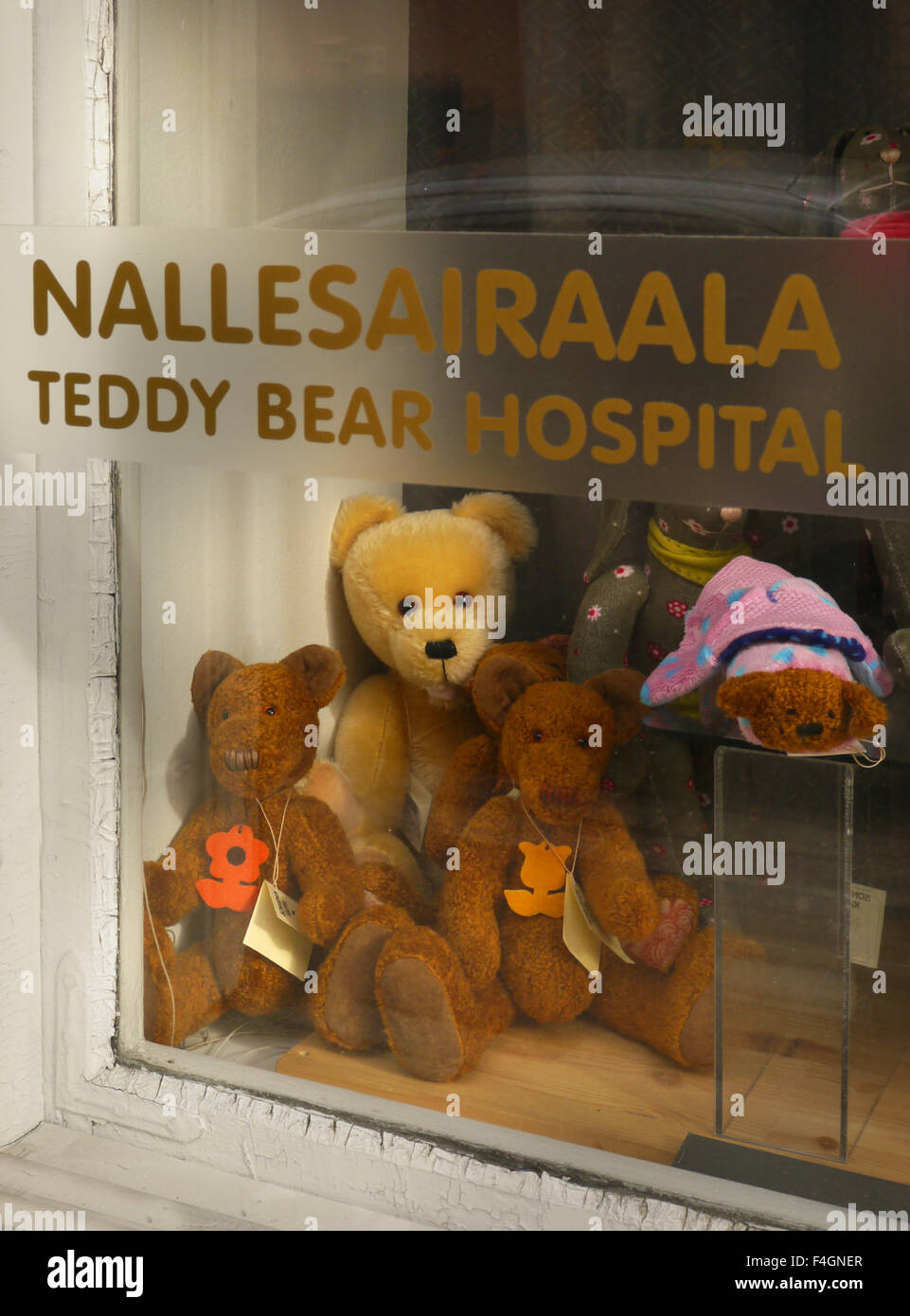 A group of sad looking toys in a teddy bear hospital window in Helsinki, Finland Stock Photo
