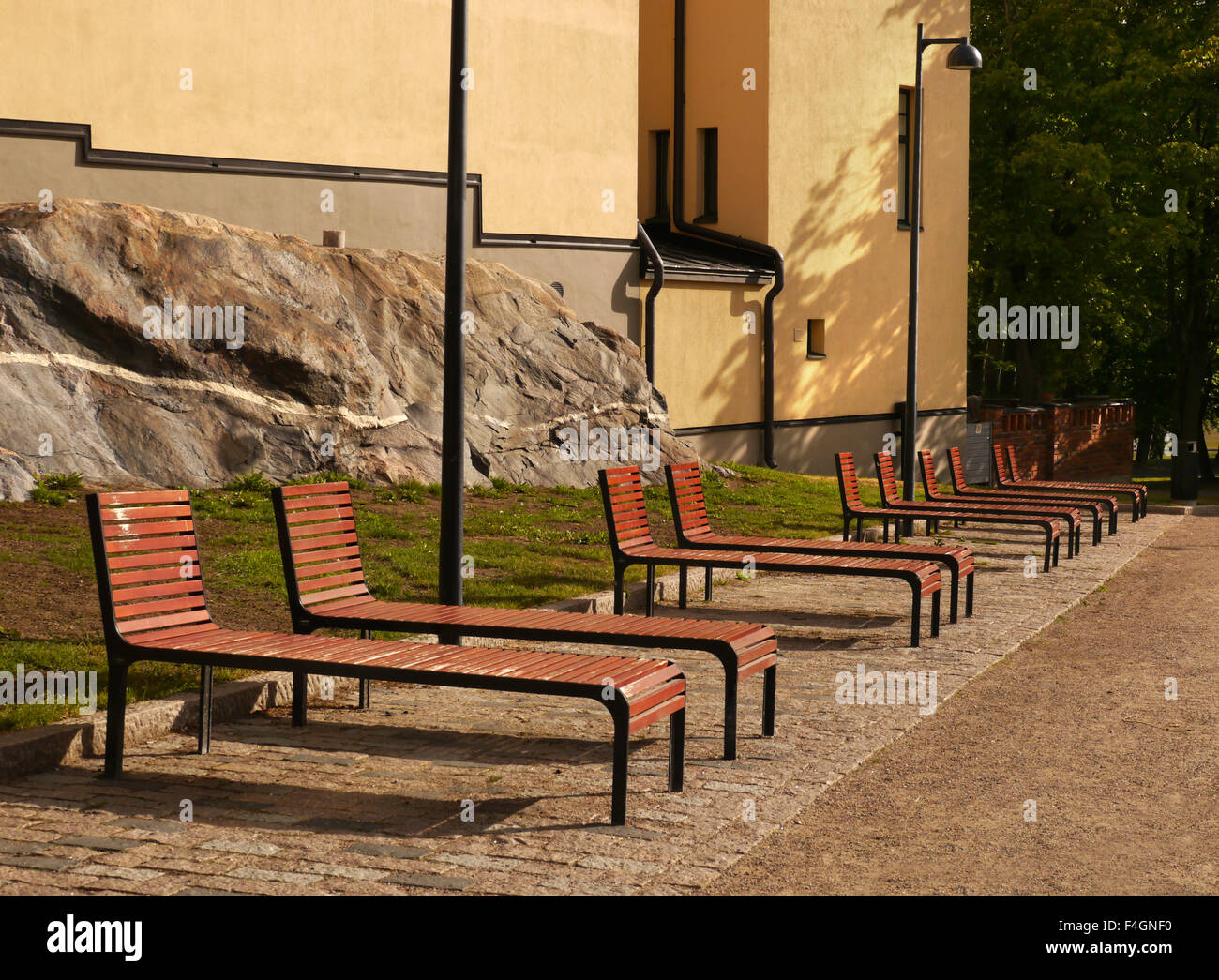 Public park bench style sun beds in Helsinki Finland Stock Photo