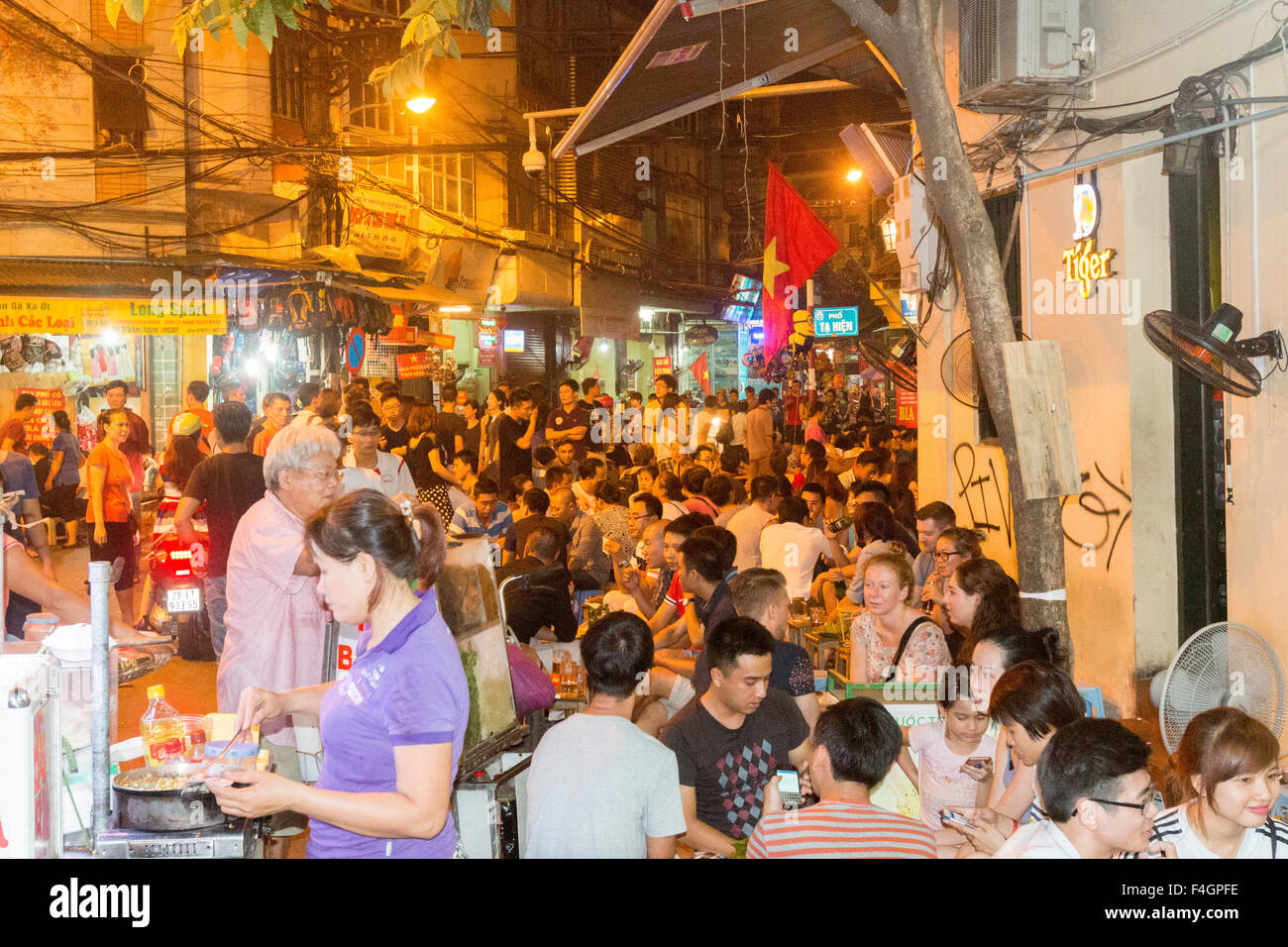 evening, Hanoi old quarter is packed in the evening with people enjoying street food and drinks at the many bars,Hanoi,Vietnam Stock Photo