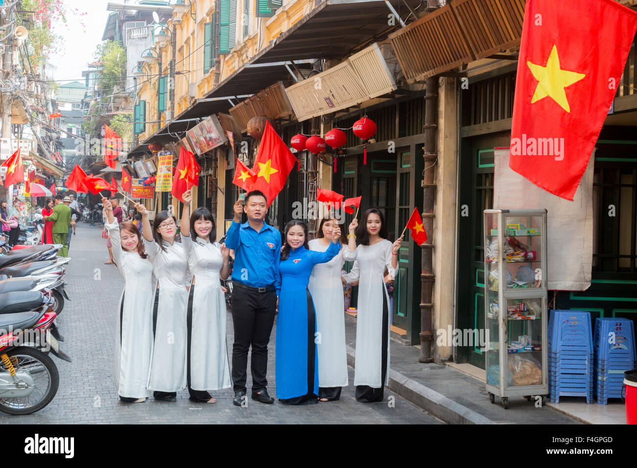 bride and groom in blue celebrate their wedding in Hanoi old quarter,with bridesmaids,Vietnam,Asia Stock Photo