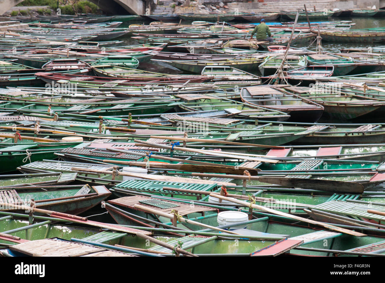 tourist row boats await customers at Tam Coc ngo dong river harbour, Ninh Binh,North vietnam Stock Photo