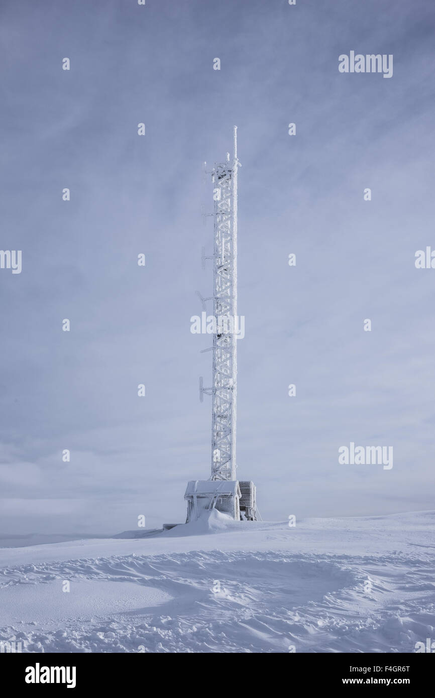 Mobile antennas and TV signal tower covered in snow Stock Photo