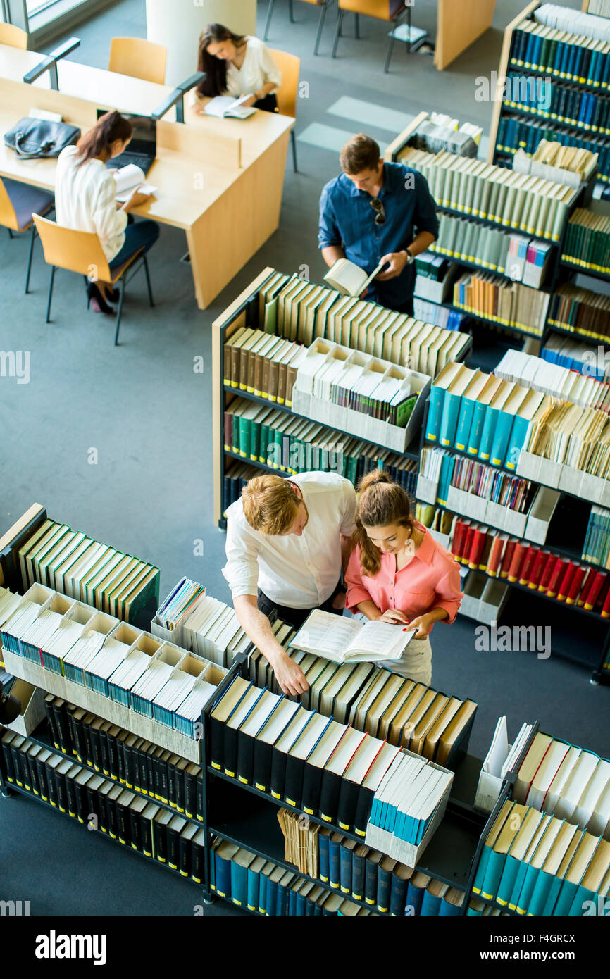Young people in the library Stock Photo - Alamy