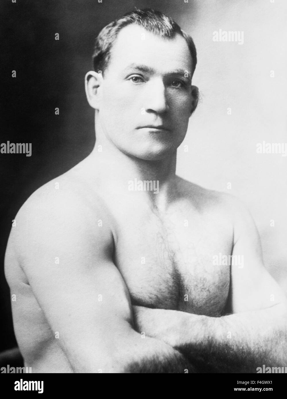 Vintage portrait photo of heavyweight boxer 'Sailor' Tom Sharkey (1873 - 1953). Sharkey, born in Dundalk, Ireland, ran away from home at a young age and went to sea as a cabin boy, eventually arriving in New York City in 1892 and joining the US Navy. He began his boxing career after being deployed to Hawaii and went on to have more than 50 bouts - fighting some of the great champions of the era including Jim Corbett, Bob Fitzsimmons and Jim Jeffries. Despite never winning the world heavyweight crown Sharkey is generally regarded as one of the great fighters of his time. Stock Photo