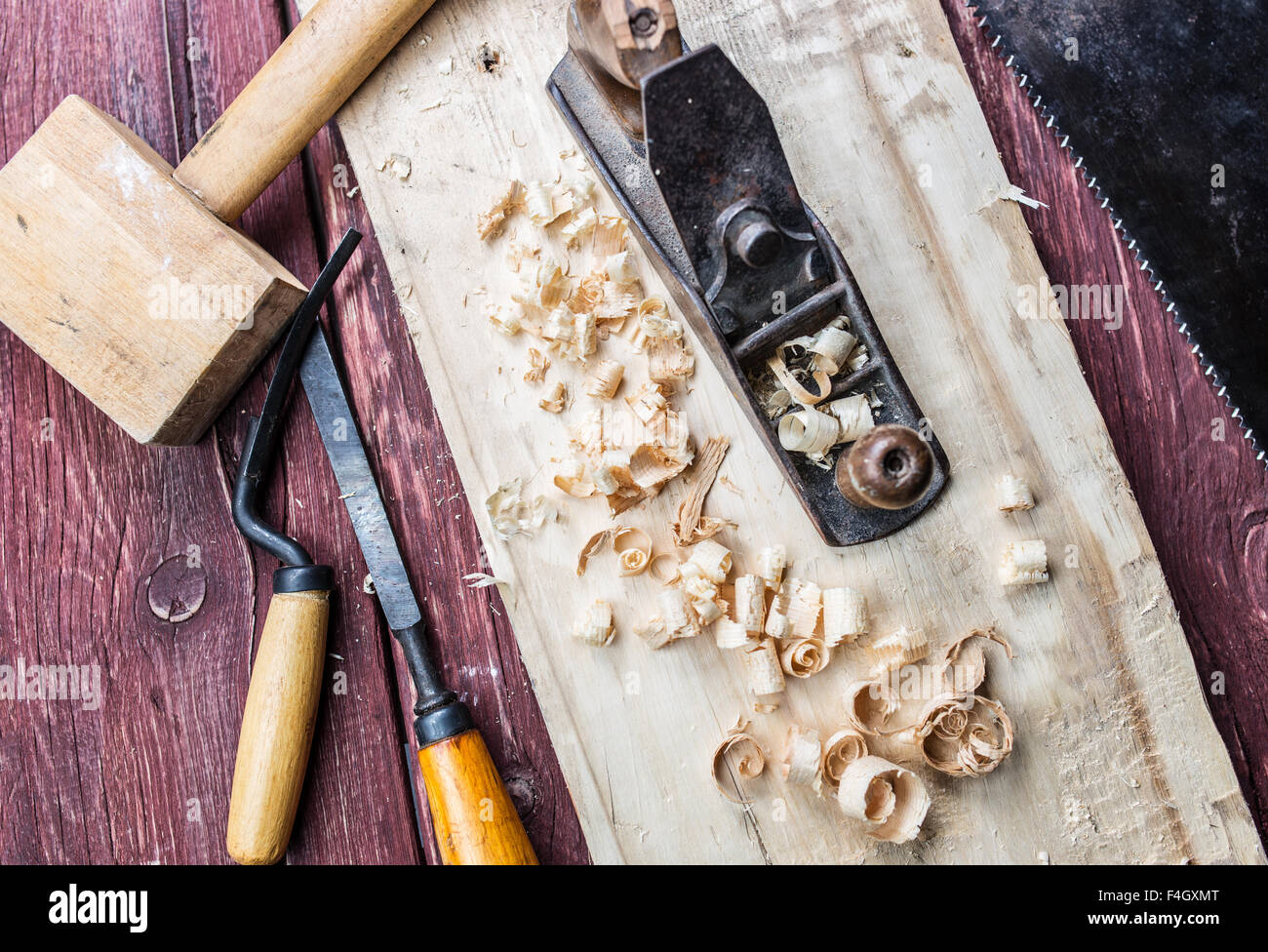 Hand jack plane, hammer, saw and other carpenter's tool on table Stock ...