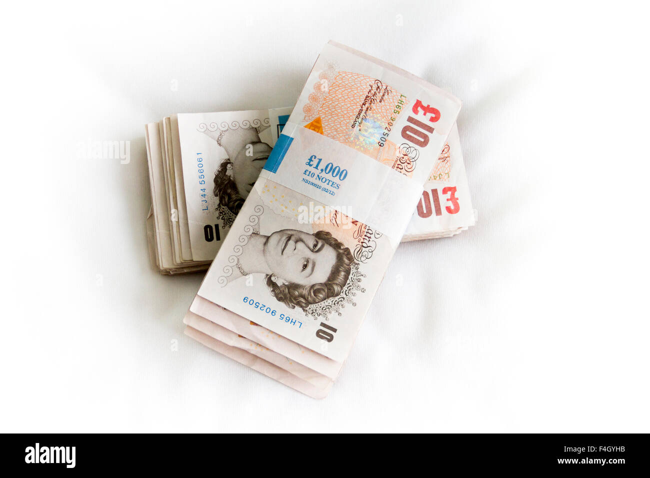 two thousand pound bundles of ten pound notes sterling Stock Photo