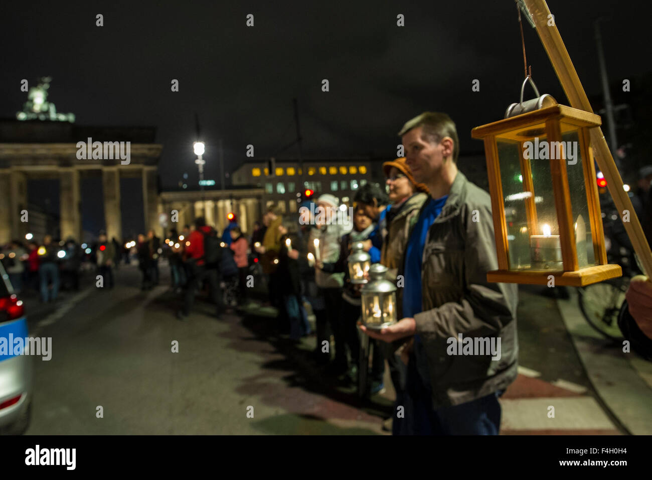 Participants hold candles in their hands during a chain of lights event
