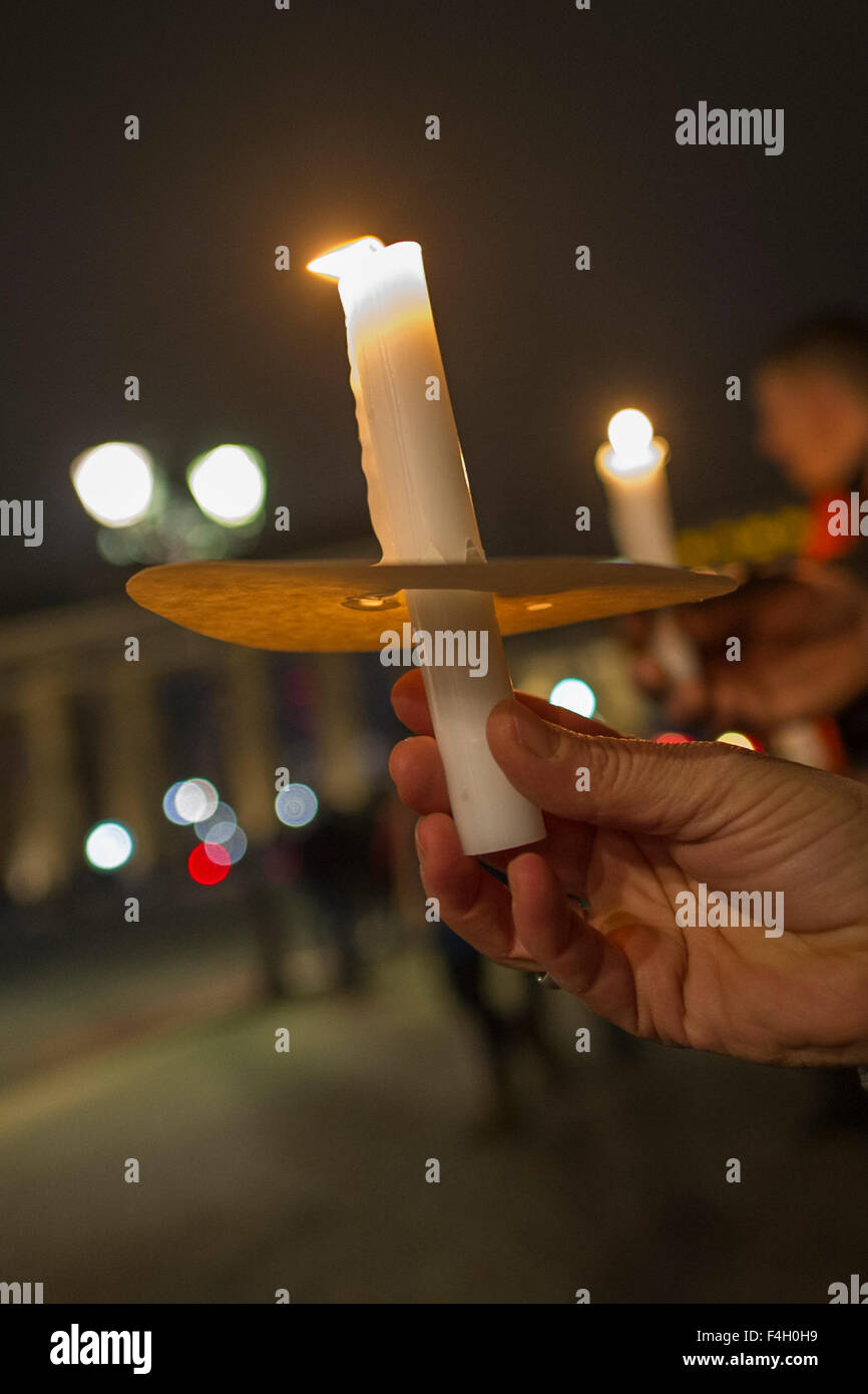 Participants hold candles in their hands during a chain of lights event