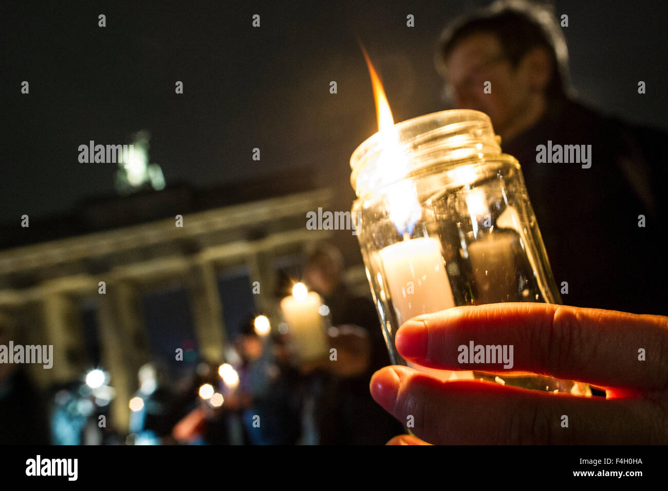 Participants hold candles in their hands during a chain of lights event