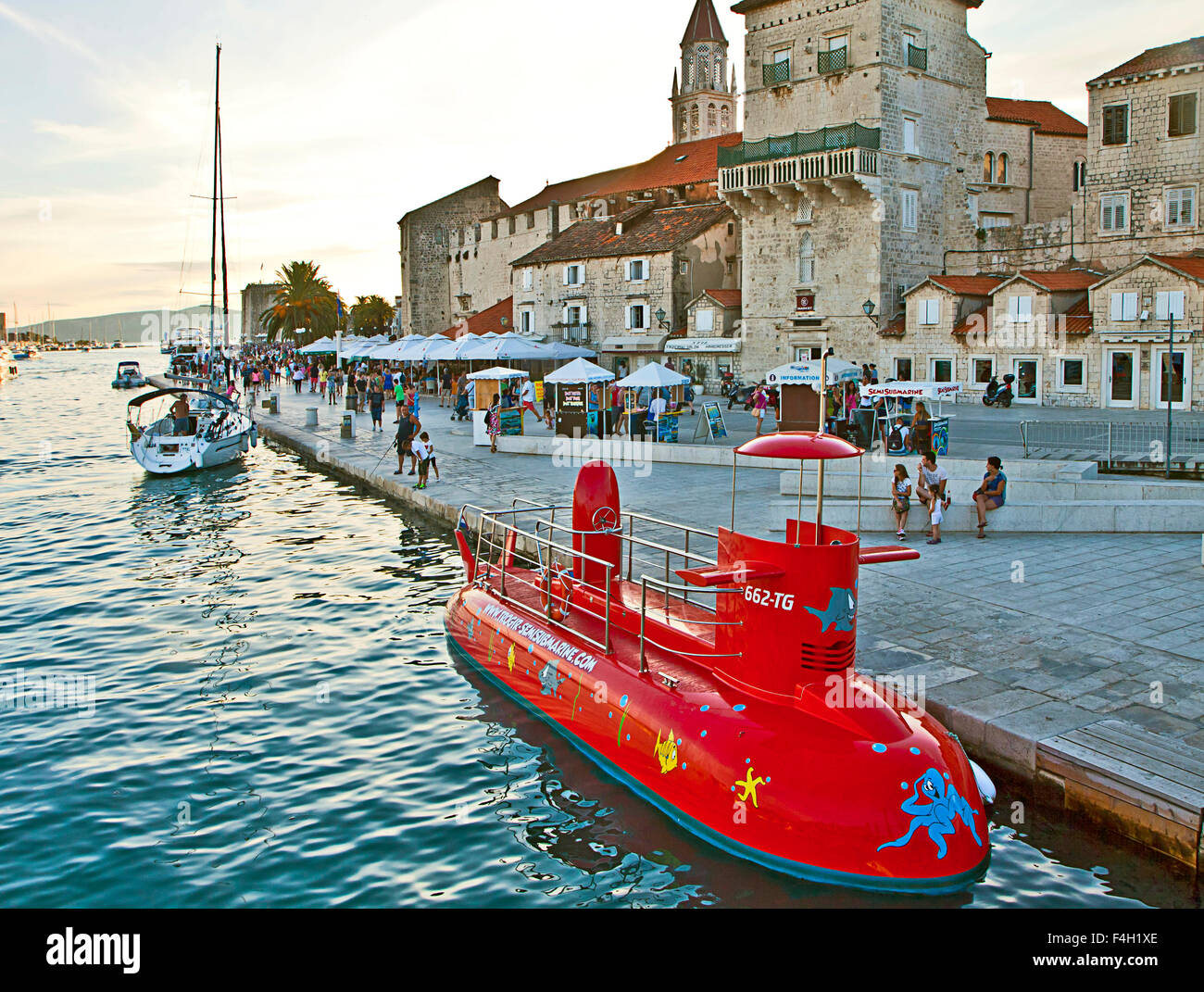 Trogir, Croatia - sea promenade with red semi-submarine moored at waterfront. Stock Photo