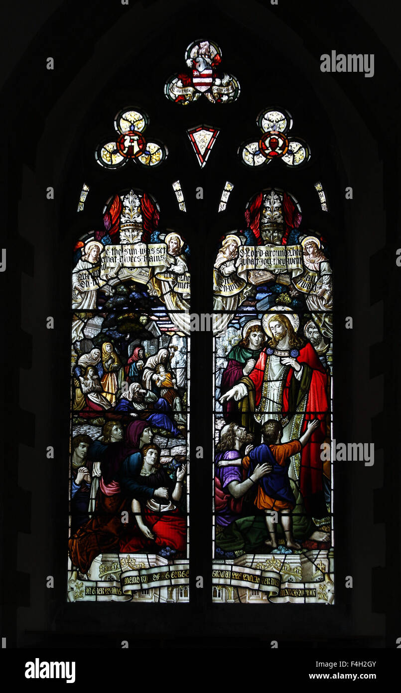 A stained glass window depicting Jesus casting out the demons and comforting the sick, St Denys Church, Kelmarsh, Northamptonshire Stock Photo