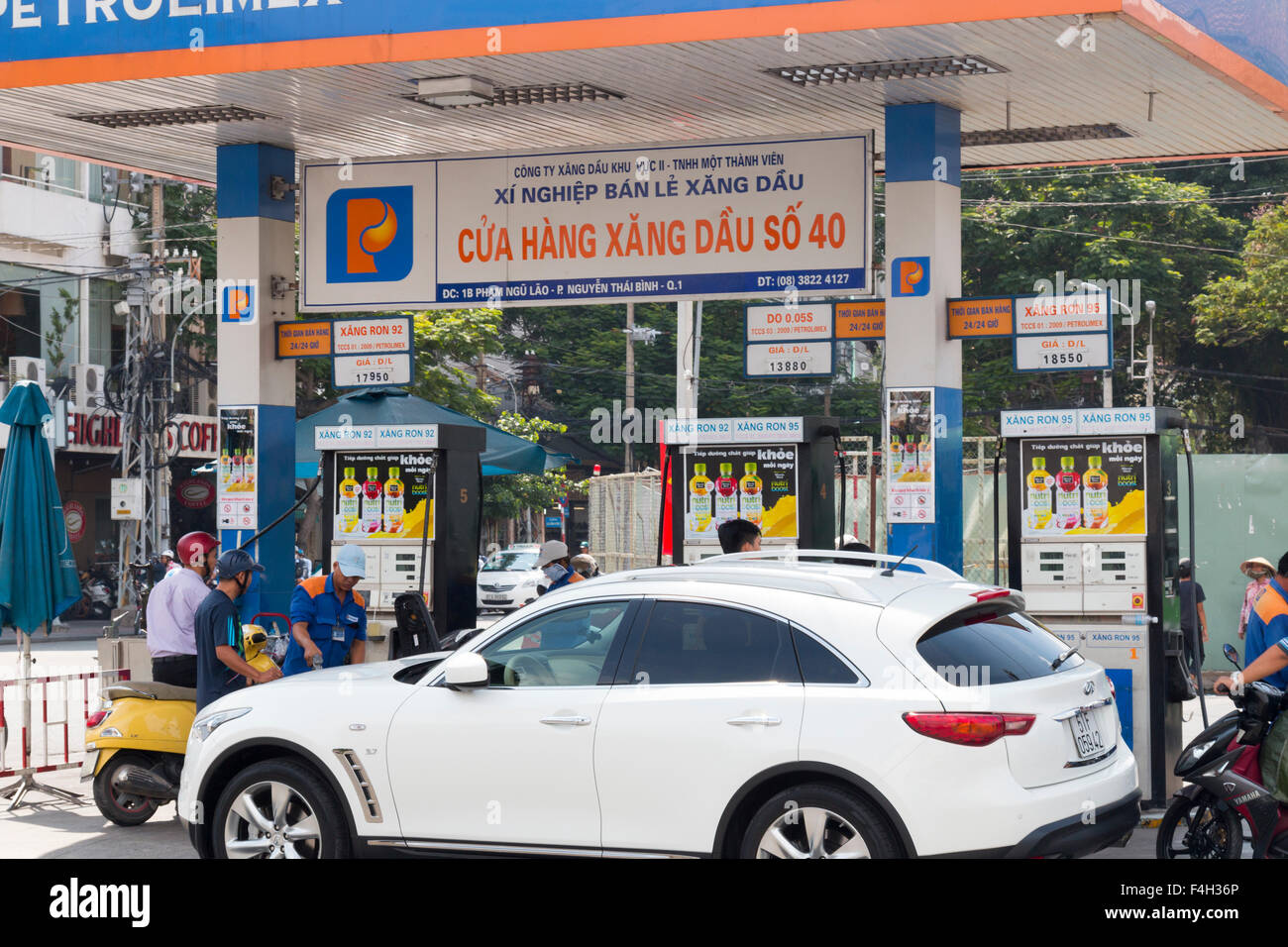 car and scooters stop for fuel at a Petrolimex gas station in Ho chi