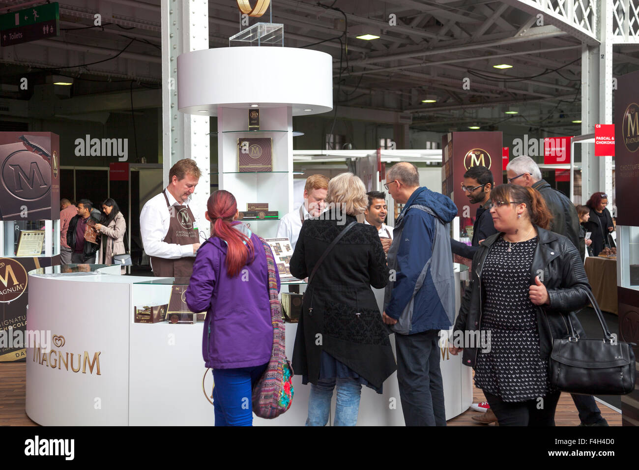 London, UK. 18th October 2015 - Magnum chocolate stall. International specialists from the chocolate industry gather at Olympia Hall to exhibit at the annual Chocolate Show in London, UK’s largest chocolate event. Activities include workshops, presentations by famous chefs, demonstrations and a chocolate fashion show. Credit: Nathaniel Noir/Alamy Live News Stock Photo