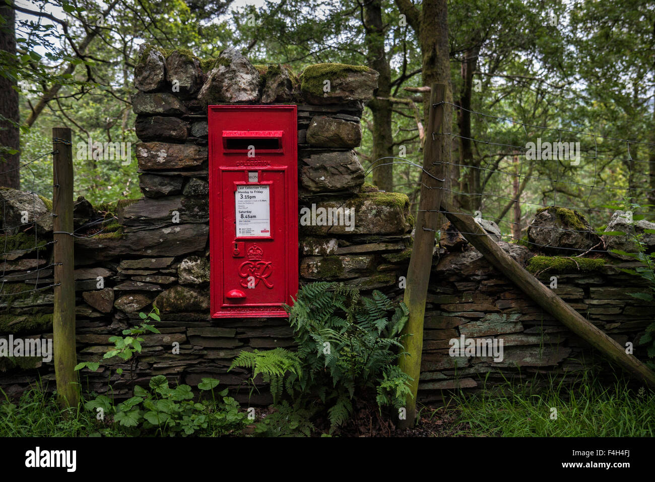 Red royal mail post box in a dry stone wall near Keswick in the Lake District National Park, Cumbria, England, UK Stock Photo