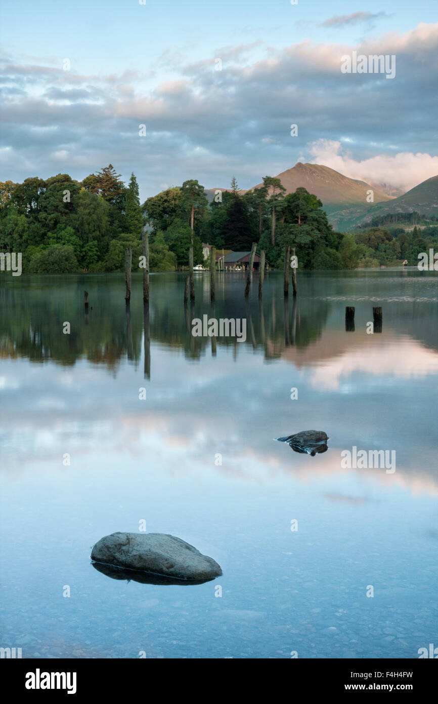 View across Derwent Water to Derwent Isle, old jetty, boathouse and fells, Keswick, Lake District National Park, Cumbria, England, UK Stock Photo