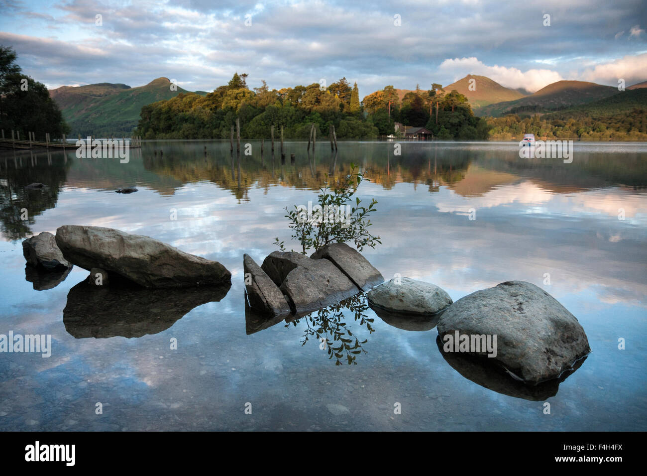 Reflections at sunrise on Derwent Water with Catbells in the background near Keswick, Lake District National Park, Cumbria, England, UK Stock Photo