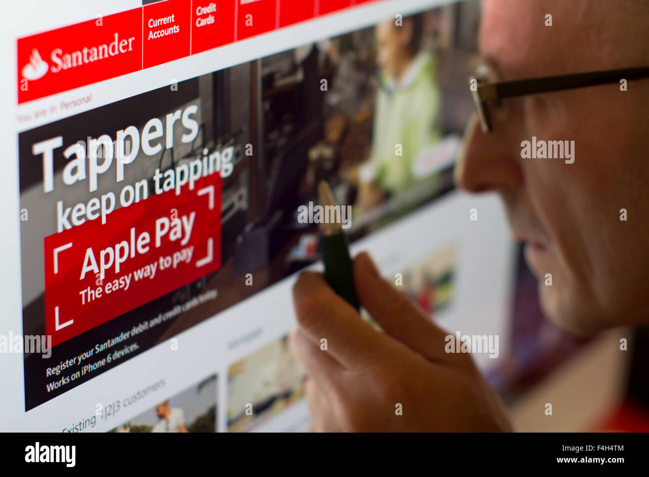Person Looking At Website Of Online Bank Santander With Apple Pay Logo Stock Photo Alamy