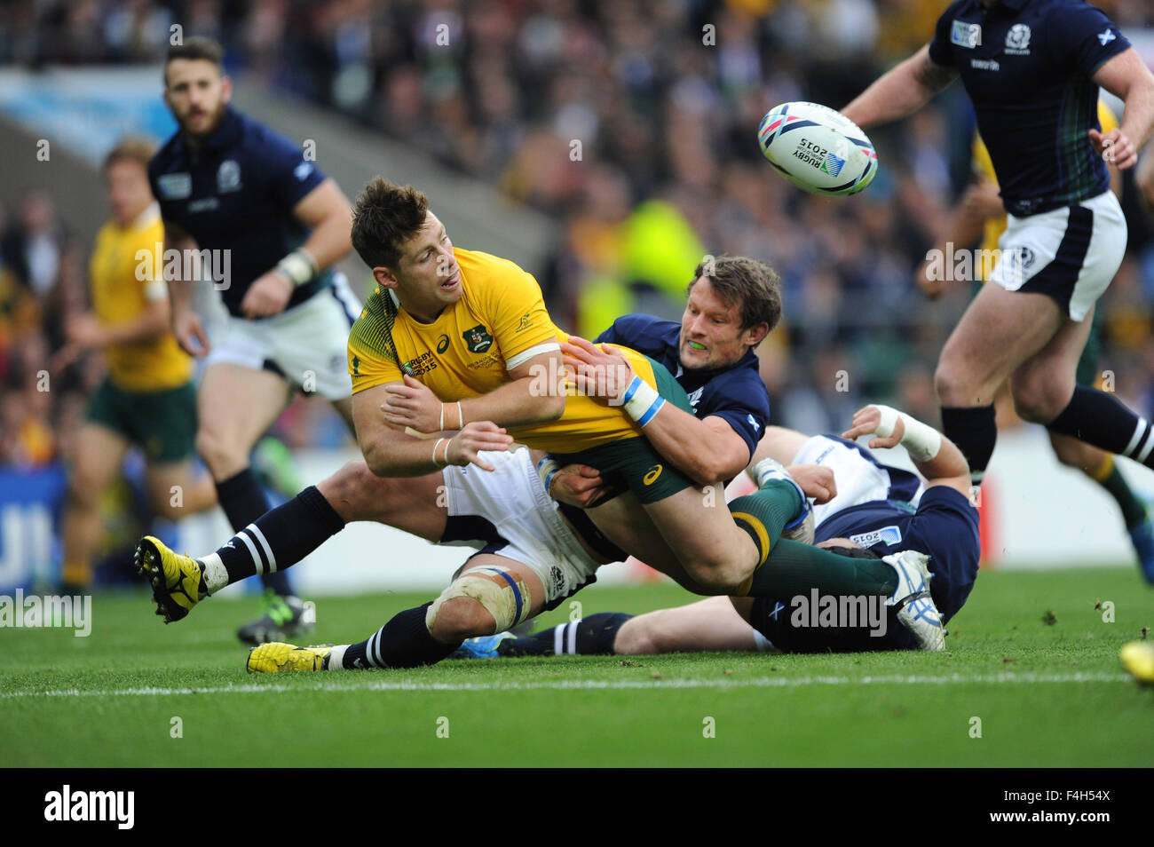 18 October 2015: Bernard Foley of Australia offloads as he is tackled just short of the line by Peter Horne of Scotland during the Quarter Final of the Rugby World Cup 2015 between Australia and Scotland - Twickenham Stadium, London.(Photo by: Rob Munro/Stewart Communications/CSM) Stock Photo