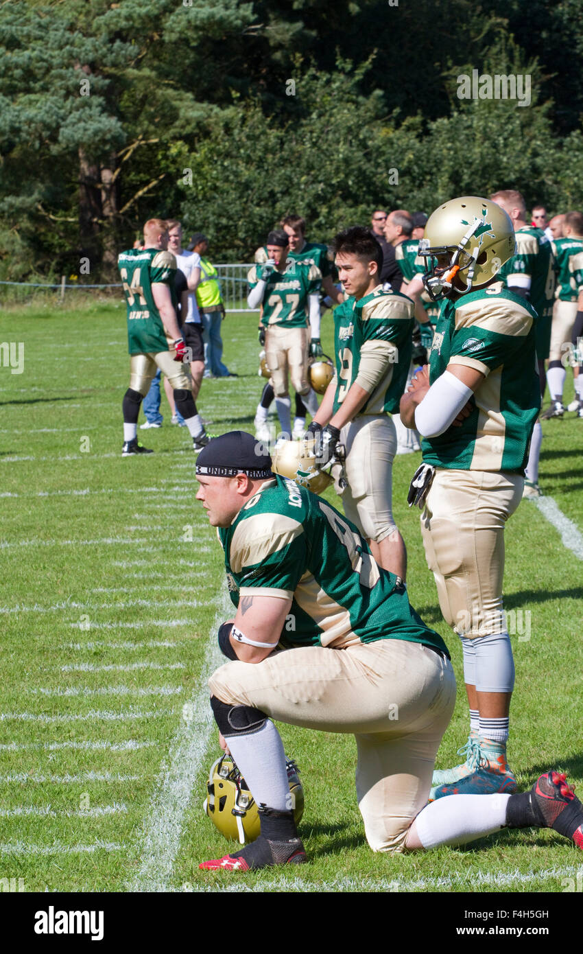 Bury Saints American football team players wait on the sideline for the start of a match Stock Photo