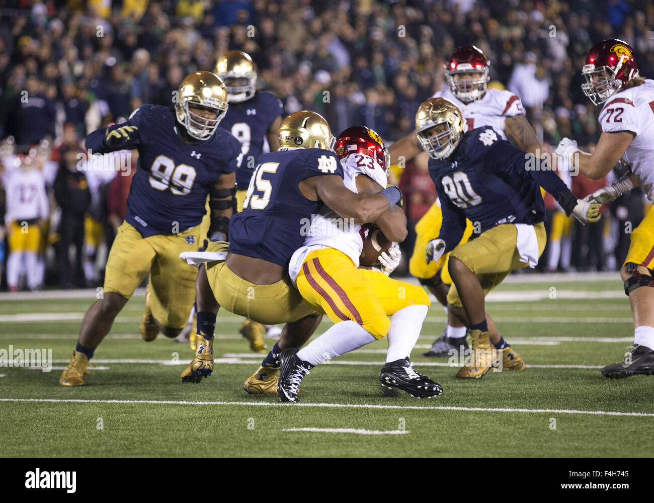 South Bend, Indiana, USA. 17th Oct, 2015. Notre Dame defensive lineman Romeo Okwara (45) tackles USC running back Tre Madden (23) during NCAA football game action between the USC Trojans and the Notre Dame Fighting Irish at Notre Dame Stadium in South Bend, Indiana. Notre Dame defeated USC 41-31. John Mersits/CSM. © csm/Alamy Live News Stock Photo