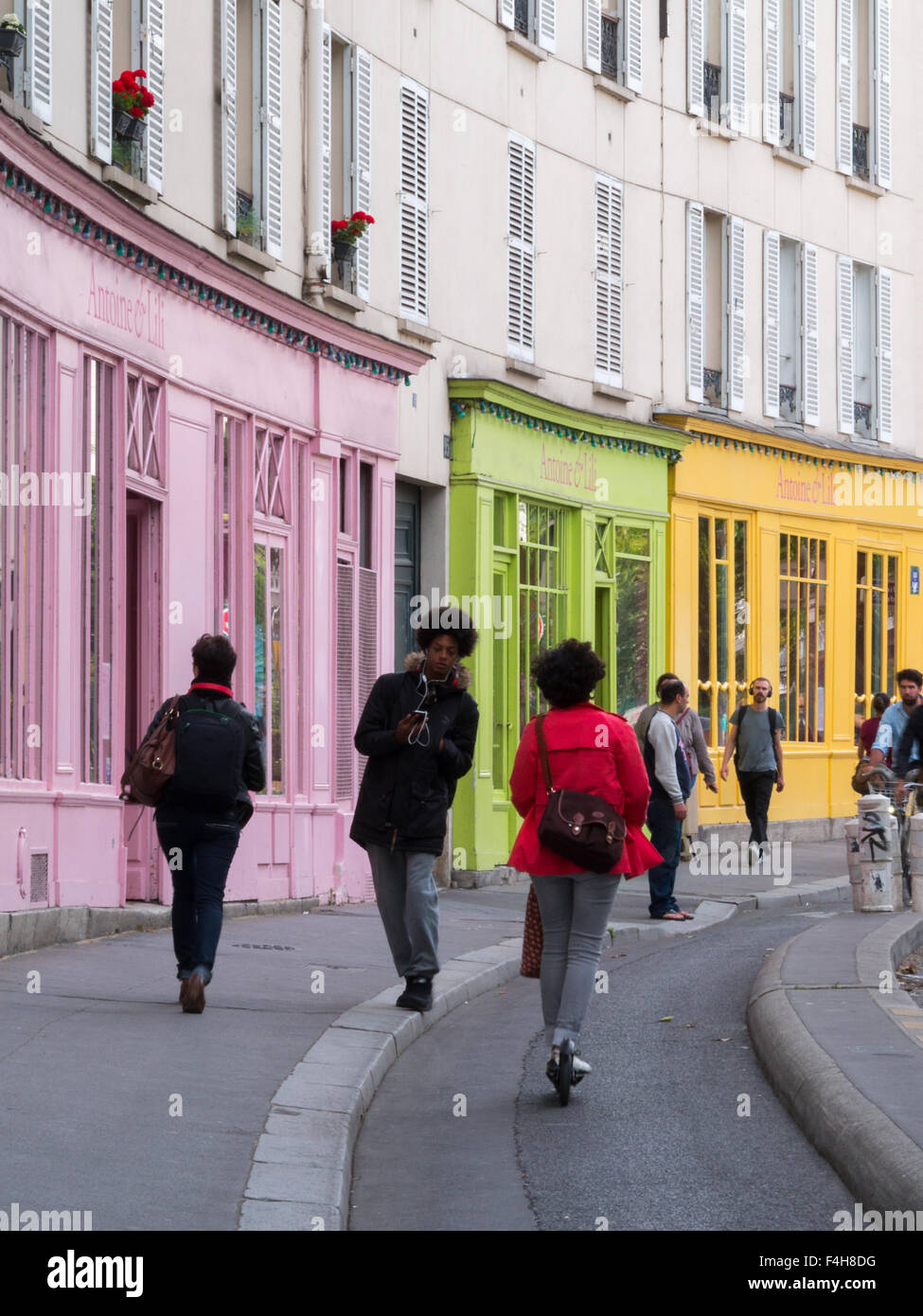 Parisian pedestrians by a colorful building Stock Photo