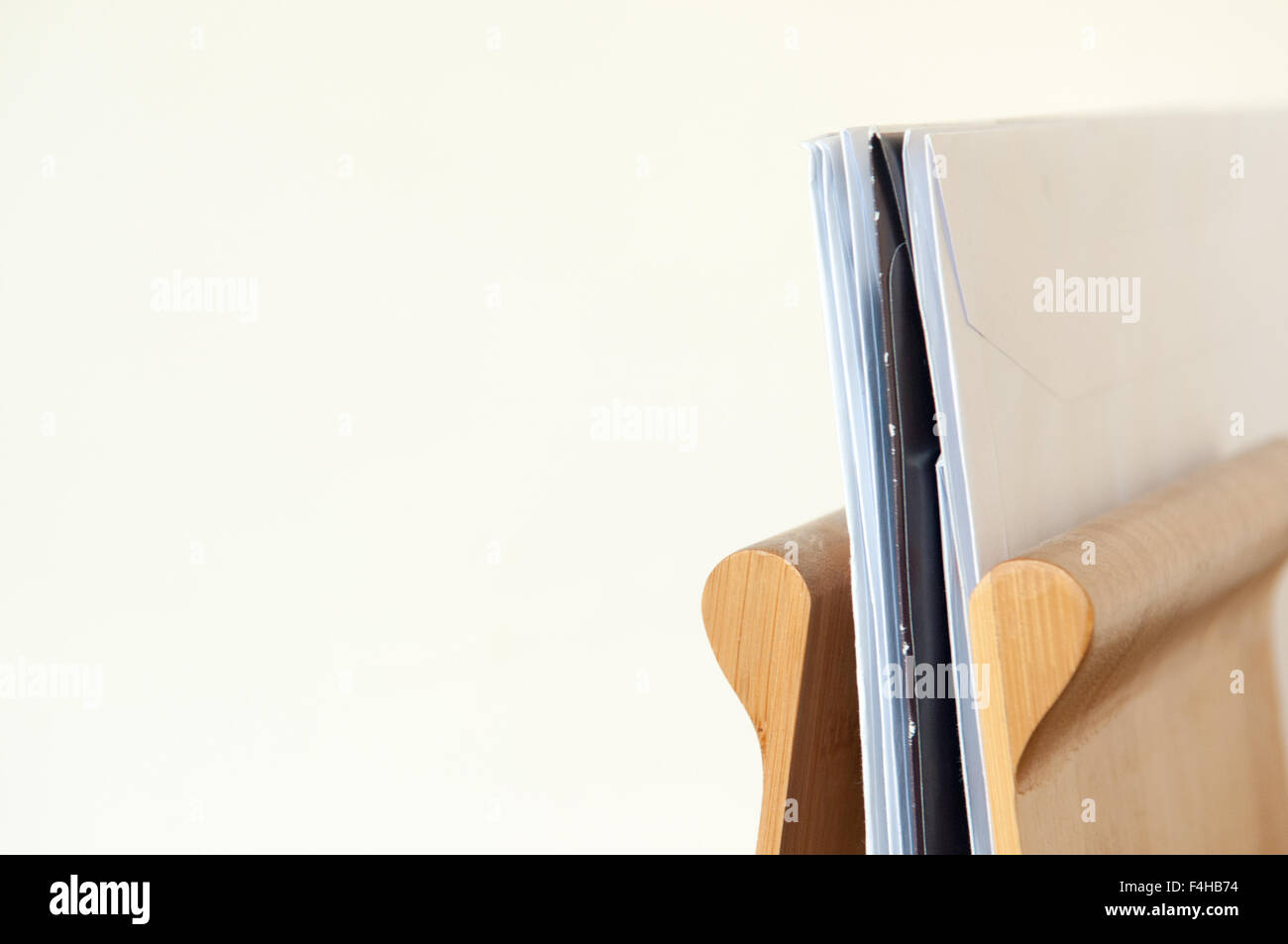 Unopened mail piled up in a wooden letter rack Stock Photo