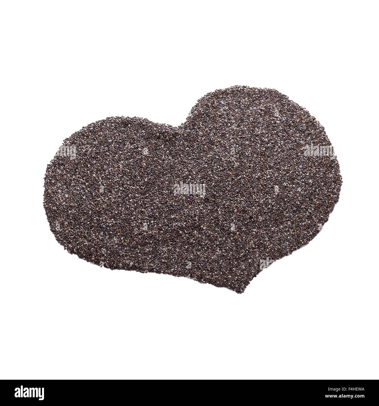 Heart shape symbol made from dry black chia seeds on white Stock Photo