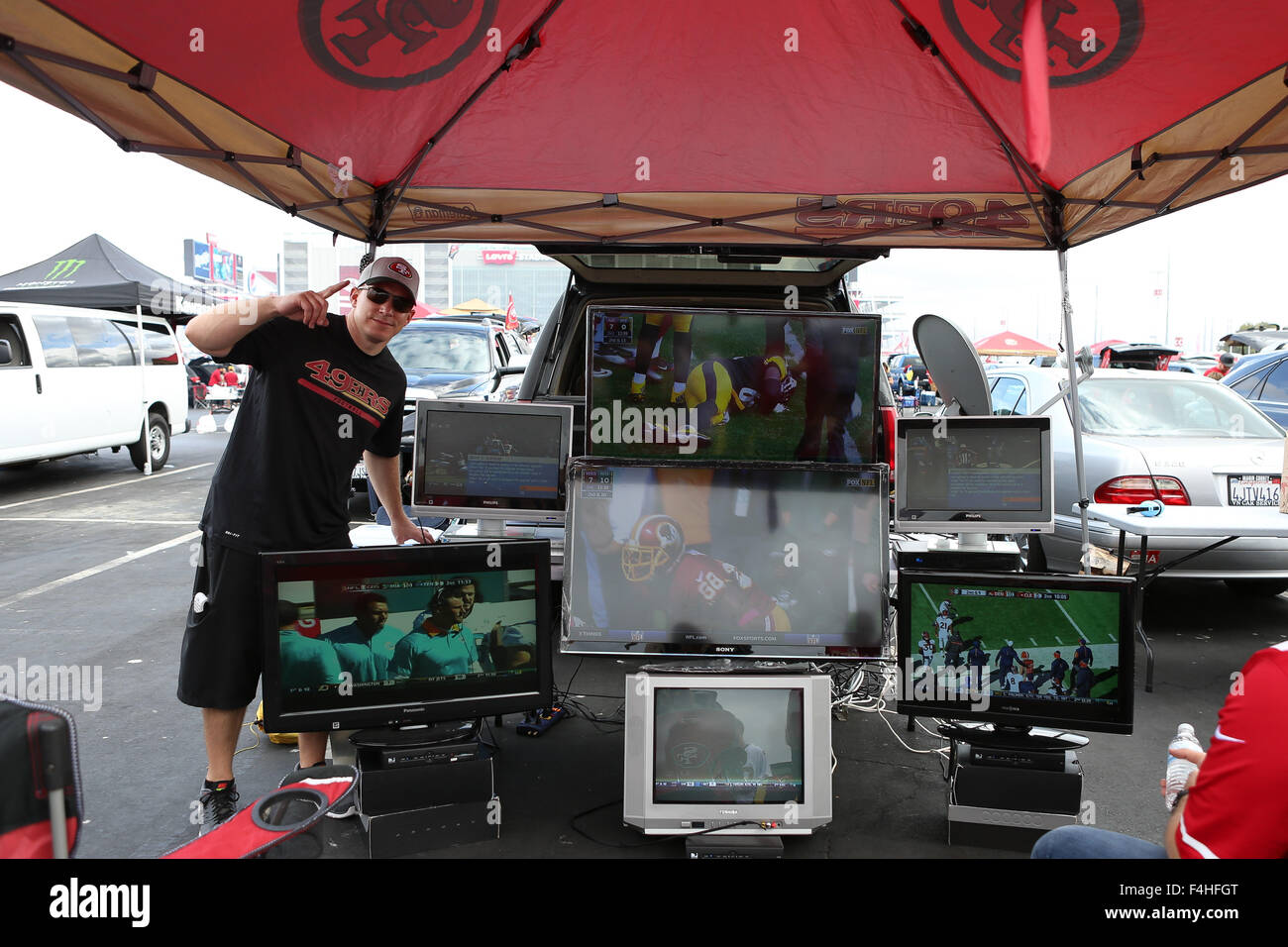 October 18, 2015: A 49ers fan shows off his seven television setup at a  tailgating event in the parking lot of Levi's Stadium prior to the start of  the NFL football game