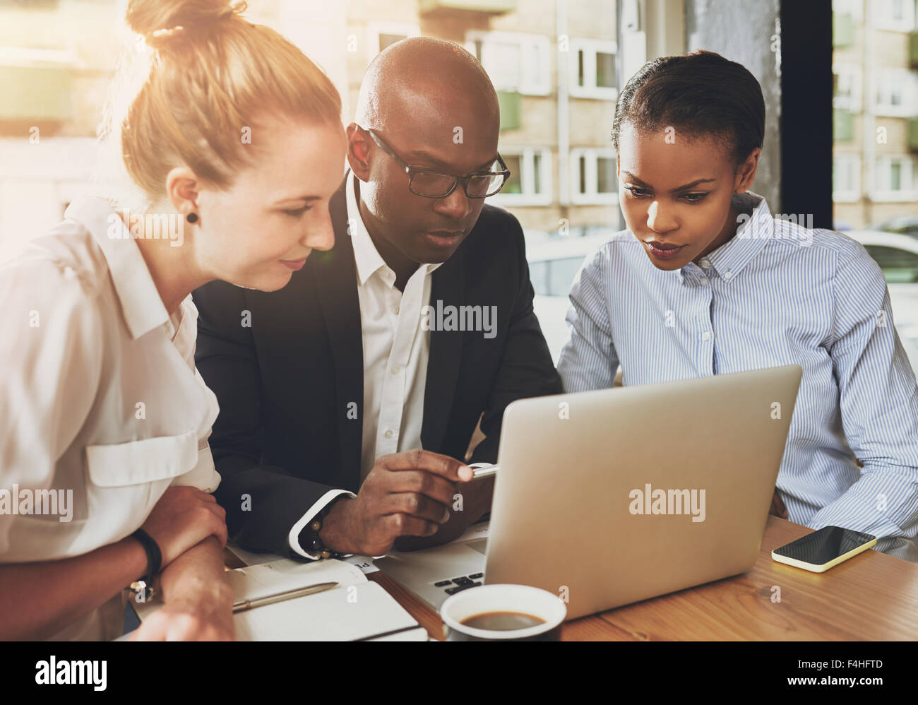 Black and white business people working together at small office Stock ...
