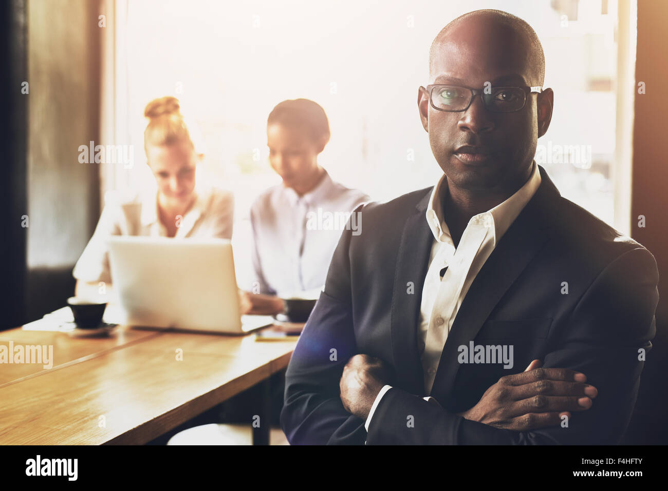 Confident succesful black business man in front of group of people Stock Photo