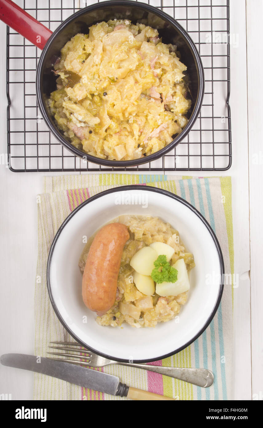 home made cabbage stew and sausage in a bowl Stock Photo