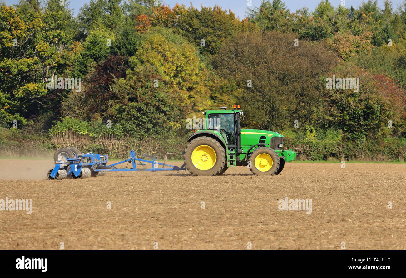 Tractor Tilling a Field in early Autumn Stock Photo