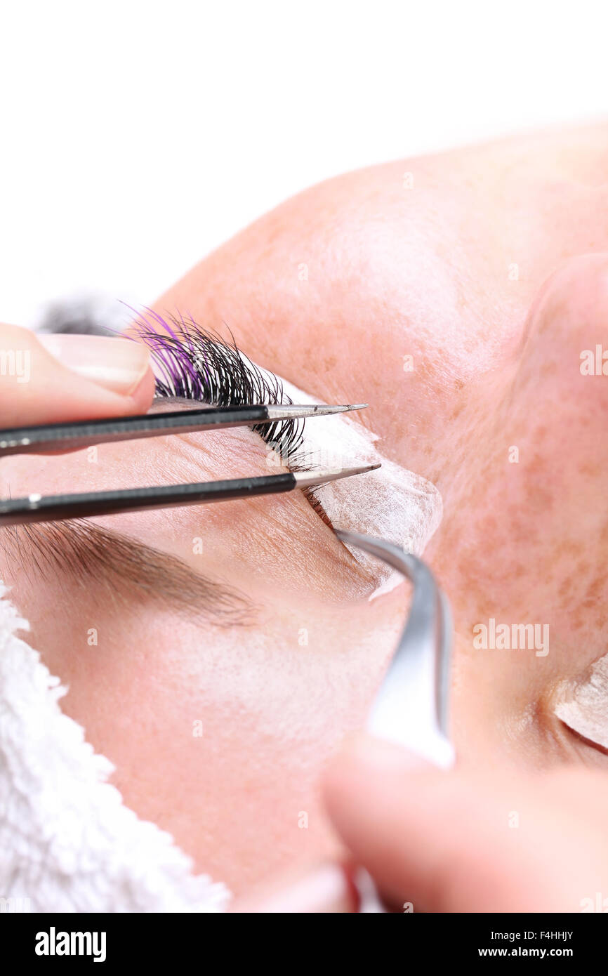 Lash making process, extreme long lashes and tweezers, woman eyelash extension Stock Photo