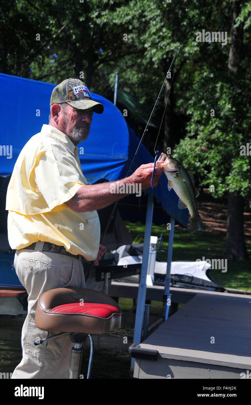 An angler lands a largemouth on a soft plastic bait from one of the