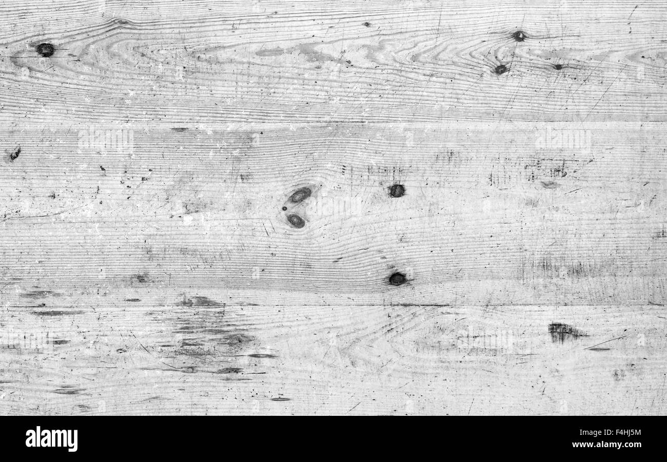Old white grungy wooden floor with cracks and scratches, background photo texture Stock Photo