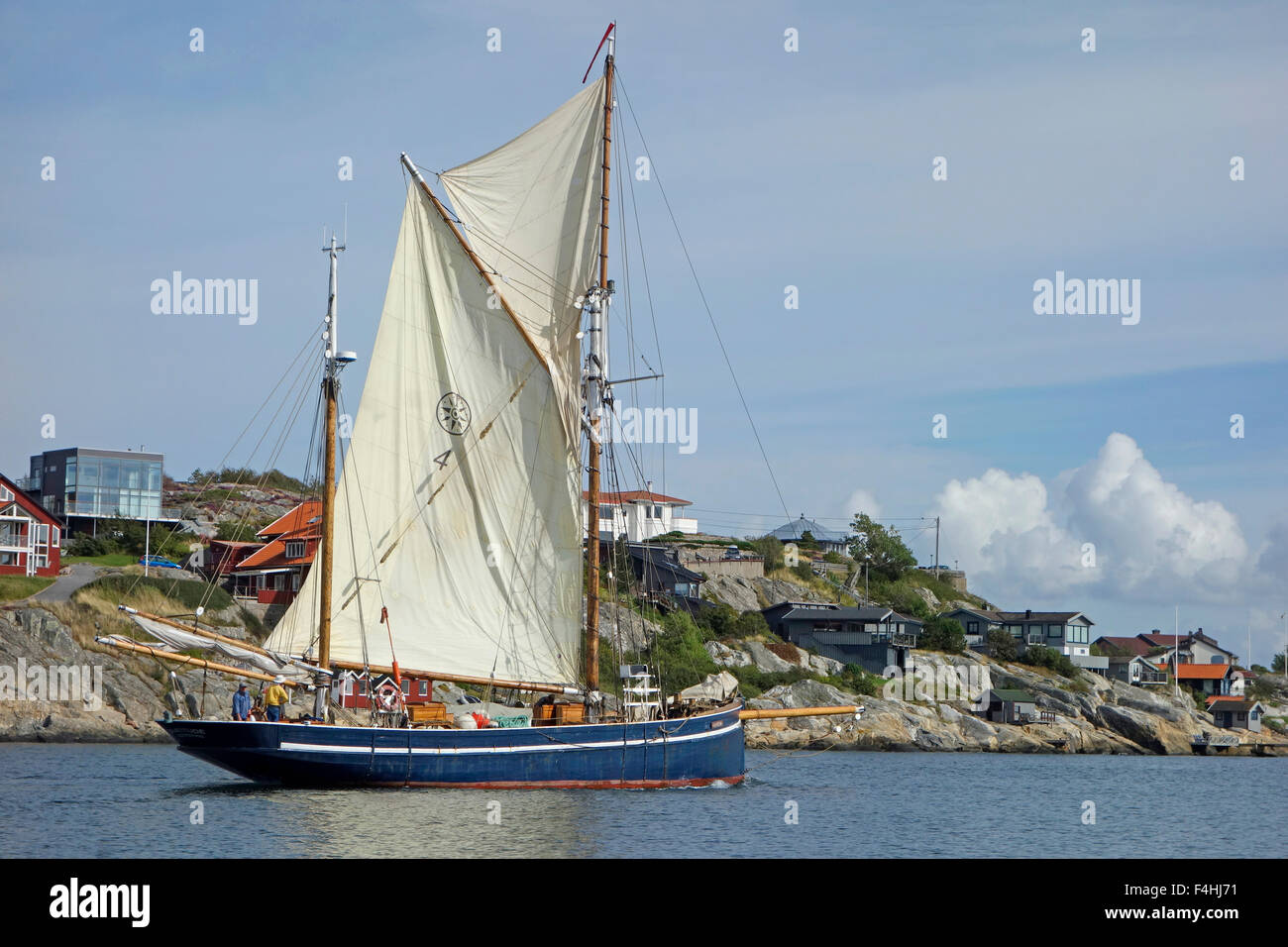 Two masted schooner  sails past by Hjuvik koast on Swedish West coast. Gothenburg, Sweden Stock Photo