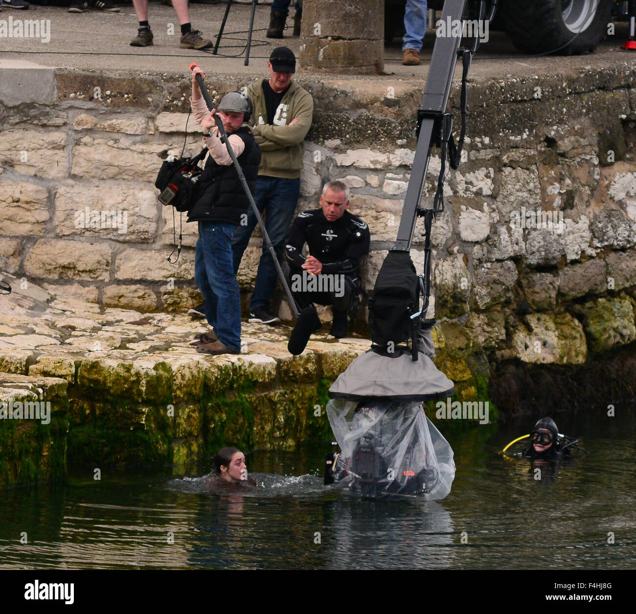 18 year old 'Game of Thrones' star Maisie Williams suffers for her art as she takes a plunge into the chilly waters of the Irish Sea in character as young Arya Stark while filming continues for season 6 of the hit US TV show in Carnlough Harbour, Northern Stock Photo