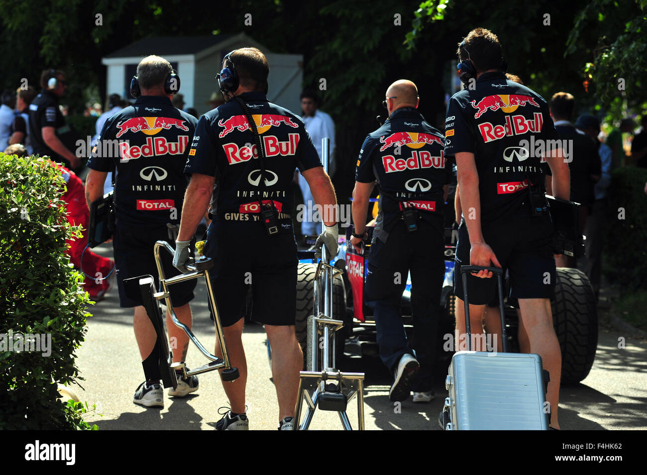 Red Bull F1 Team mechanics pull equipment into the paddock at the Goodwood Festival of Speed in the UK. Stock Photo