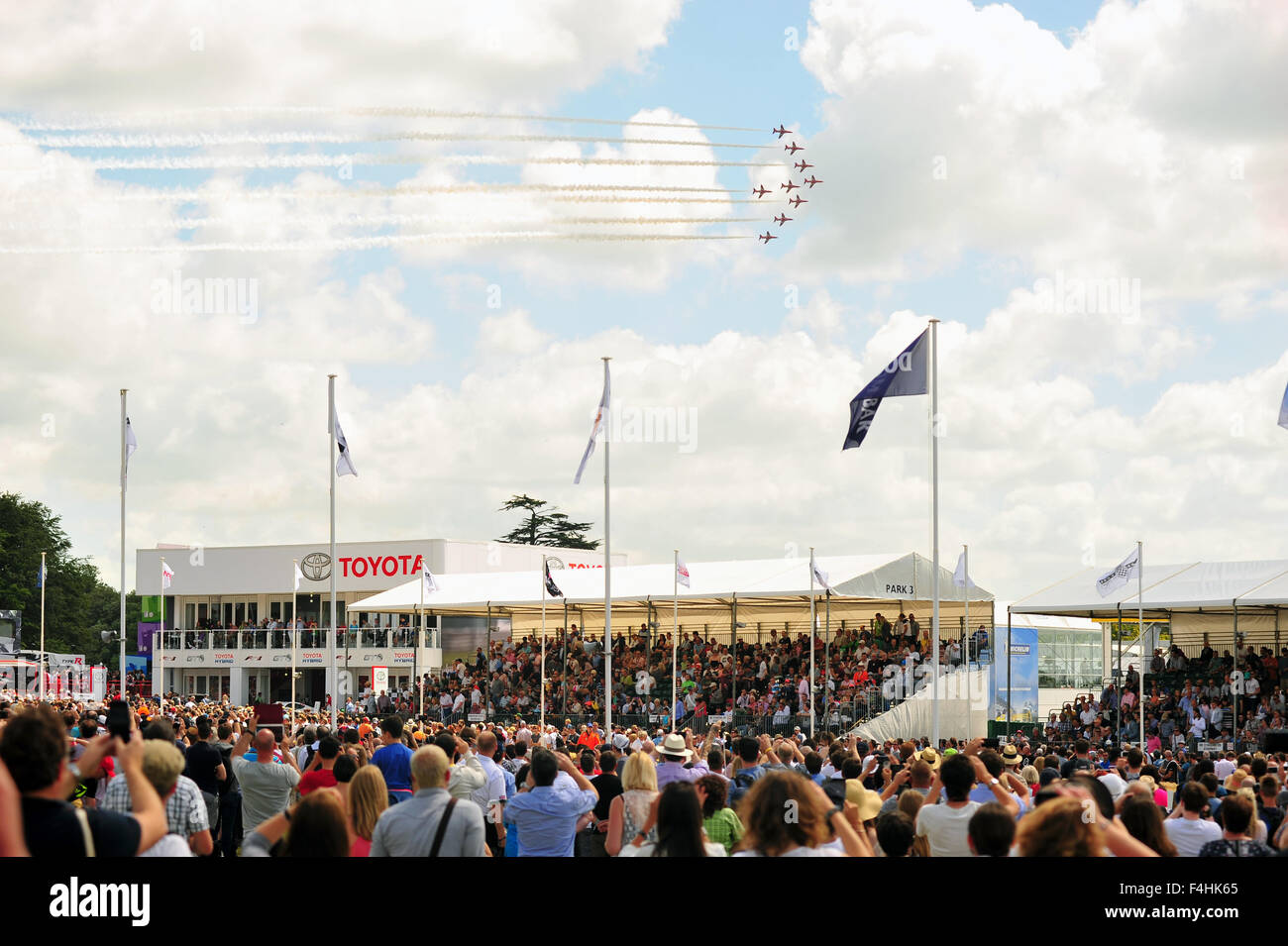 The RAF Red Arrows display team perform above the crowds at the Goodwood Festival of Speed in the UK. Stock Photo