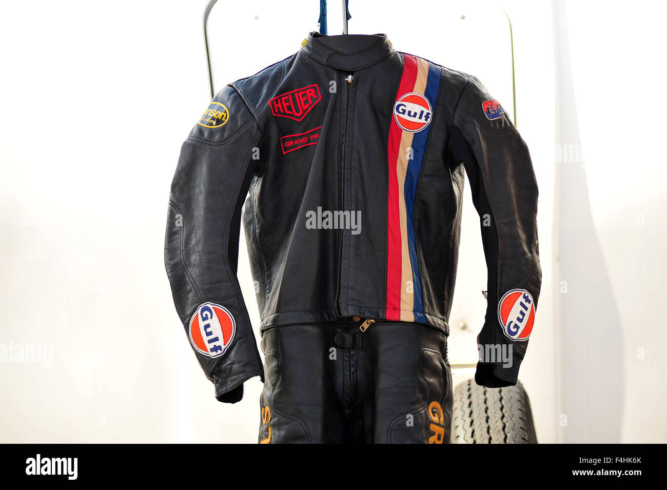 A black leather Gulf racing suit hanging in the paddocks at the Goodwood Festival of Speed hill climb in the UK. Stock Photo