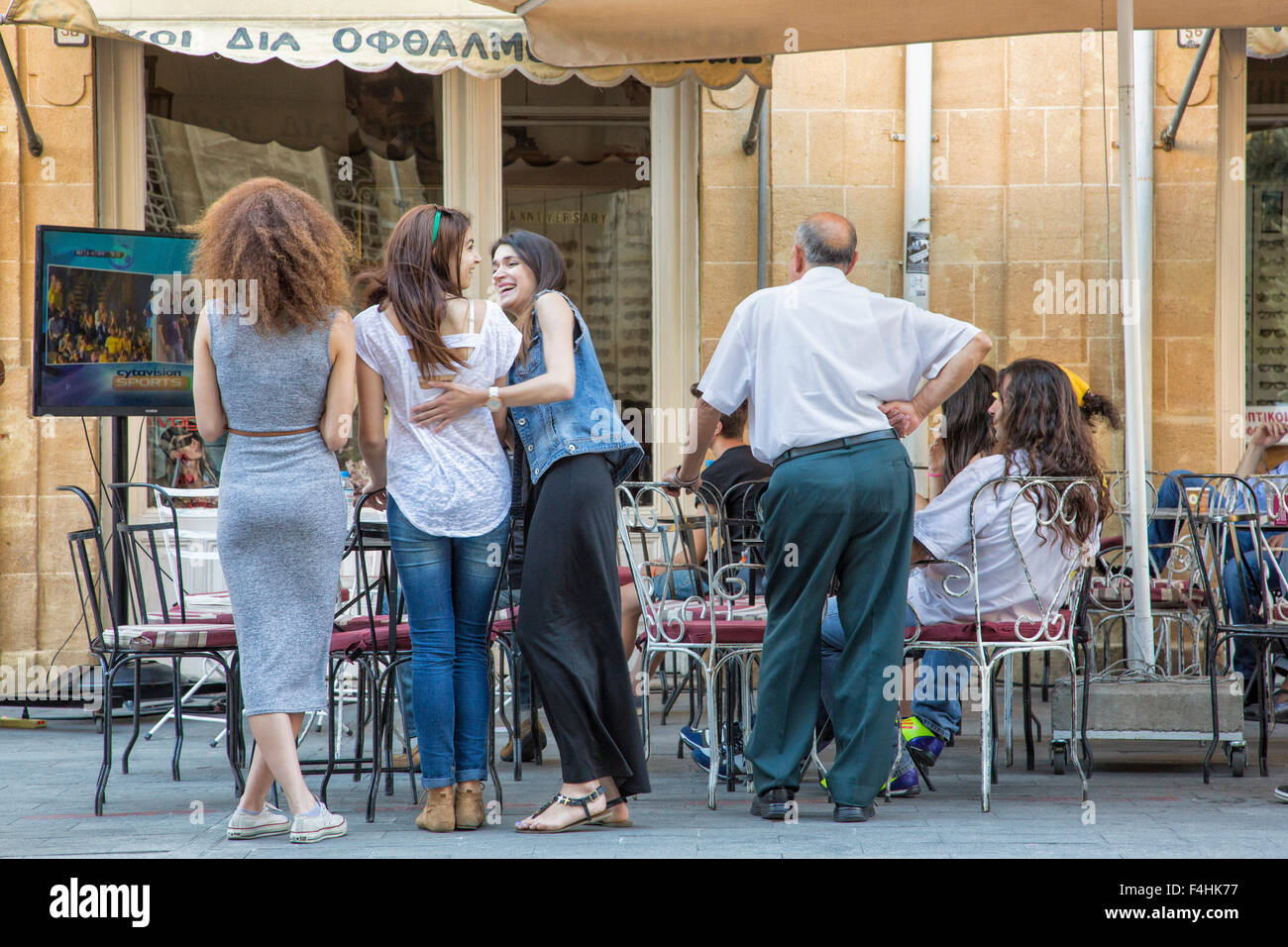 Patrons watching soccer match in outdoor cafe, Lefkosia (Nicosia), Cyprus. Stock Photo
