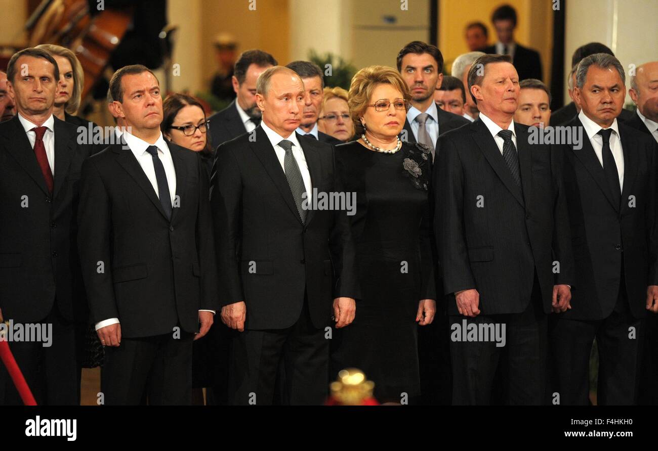 Russian President Vladimir Putin stands with his wife and government officials during the memorial service for former prime minister Yevgeny Primakov in the Hall of Columns at the House of Unions June 29, 2015 in Moscow, Russia. Putin joined thousands of mourners in bidding farewell to Yevgeny Primakov, a former prime minister who also served as Russia's top diplomat and foreign intelligence chief during a long and distinguished career. Stock Photo